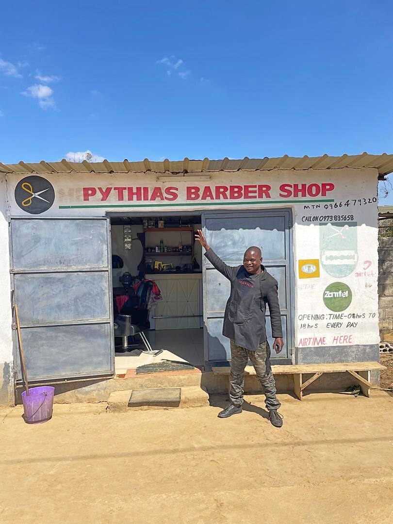 Pythias outside the shop, Makeni Bonaventure